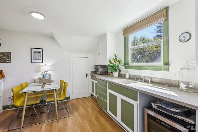 17 Hanns Ave, Vallejo, CA 94590 - kitchen featuring light wood-type flooring, a sink, and white cabinetry