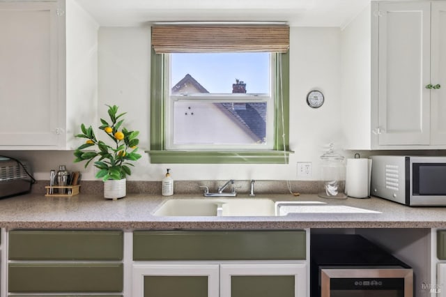 17 Hanns Ave, Vallejo, CA 94590 - kitchen with stainless steel microwave, white cabinetry, a sink, and light countertops