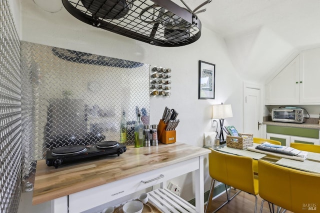 17 Hanns Ave, Vallejo, CA 94590 - kitchen featuring white cabinets, decorative backsplash, vaulted ceiling, and a toaster
