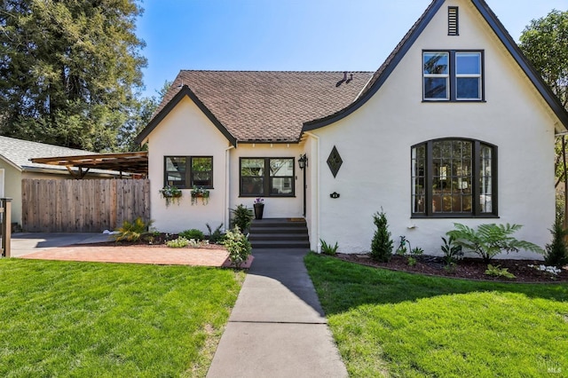 17 Hanns Ave, Vallejo, CA 94590 - tudor house with roof with shingles, a front lawn, stucco siding, and fence