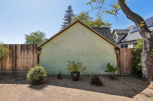 17 Hanns Ave, Vallejo, CA 94590 - view of side of home featuring stucco siding, fence, and a shingled roof