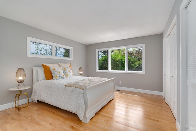 bedroom featuring light wood-type flooring and baseboards