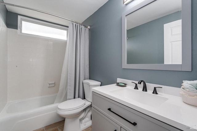 bathroom featuring shower / bath combo with shower curtain, toilet, and vanity
