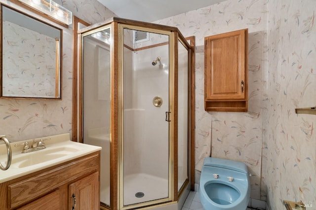 full bathroom with wallpapered walls, vanity, and a stall shower
