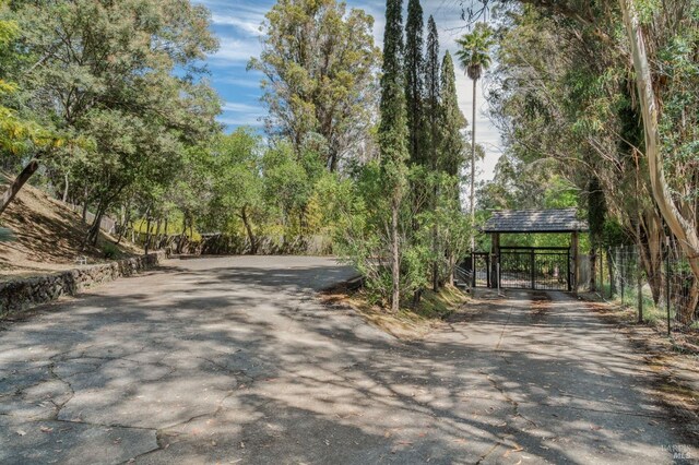 surrounding community featuring a carport and aphalt driveway