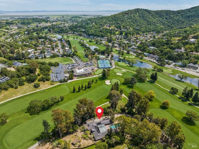 birds eye view of property featuring view of golf course, a residential view, and a water and mountain view