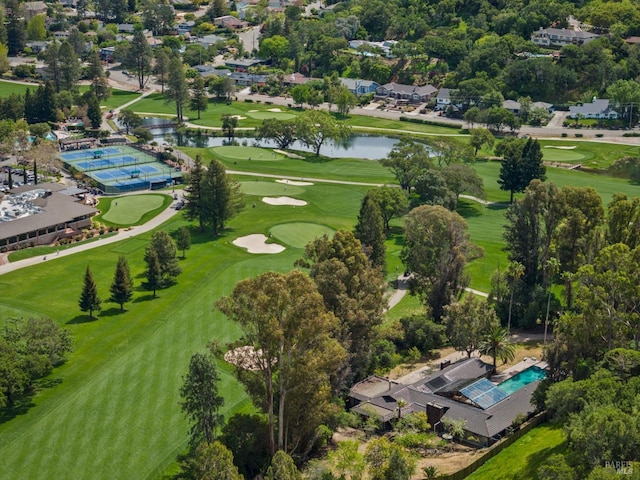 aerial view featuring golf course view and a water view