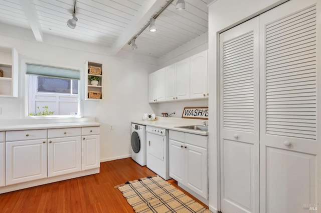 laundry room featuring light wood finished floors, a sink, baseboards, track lighting, and laundry area