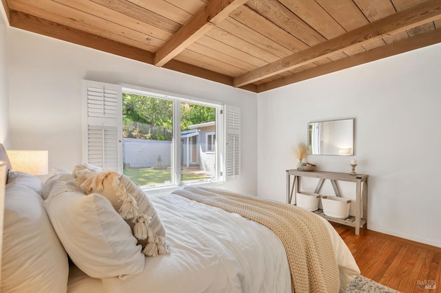bedroom featuring wood finished floors, beam ceiling, baseboards, wood ceiling, and access to outside