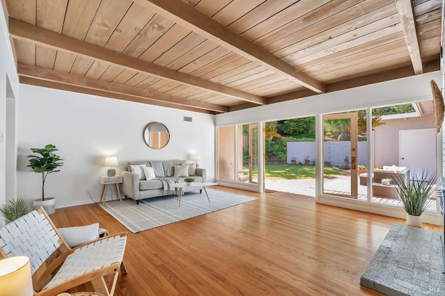 living area with beam ceiling and wood ceiling