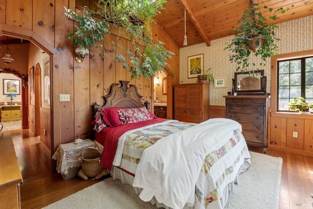 bedroom featuring wallpapered walls, lofted ceiling with beams, wood ceiling, arched walkways, and wood-type flooring