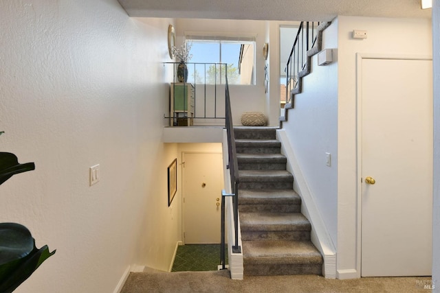 stairway with carpet floors and baseboards