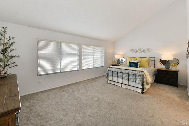 bedroom with carpet floors and lofted ceiling
