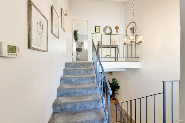 stairs with a chandelier