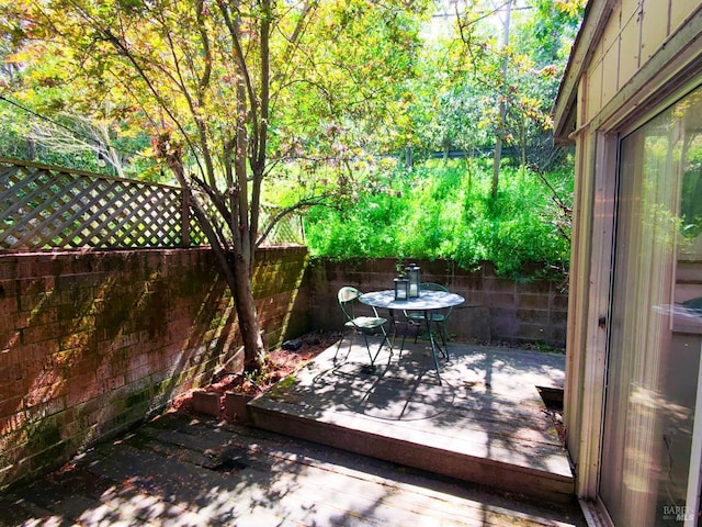 exterior space with a fenced backyard and outdoor dining space