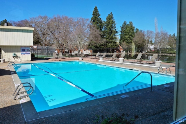 pool featuring a patio and fence