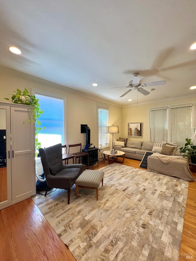 living room with crown molding, light wood finished floors, and recessed lighting