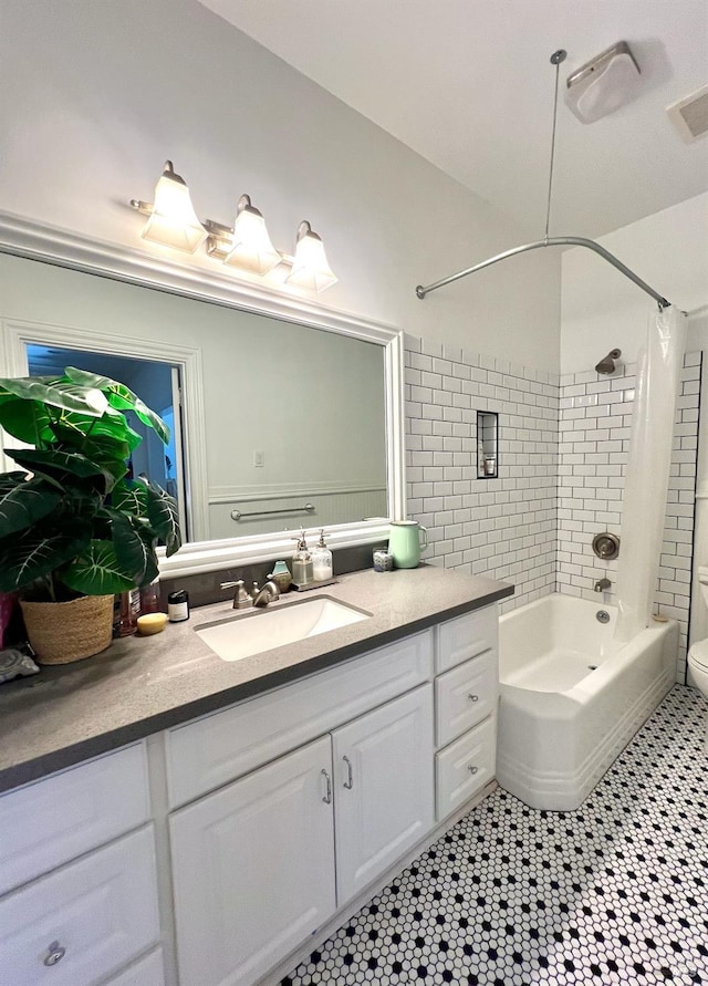 full bathroom with visible vents, toilet, vanity, and shower / washtub combination