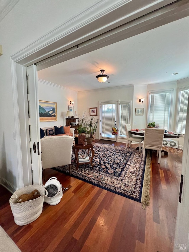 living room with wood finished floors and crown molding