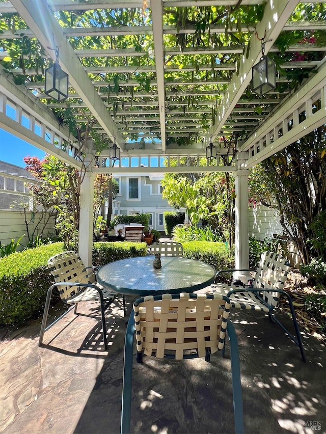 view of patio / terrace featuring a pergola and outdoor dining space
