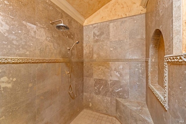 interior details with ornamental molding and a tile shower