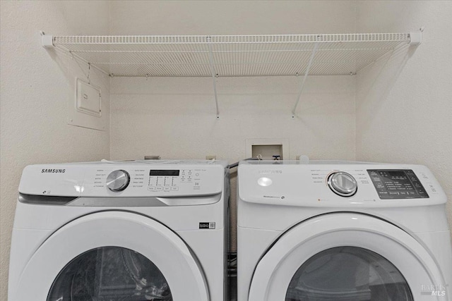 clothes washing area with washer and clothes dryer