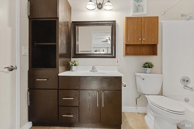 bathroom with toilet, baseboards, shower / washtub combination, and vanity