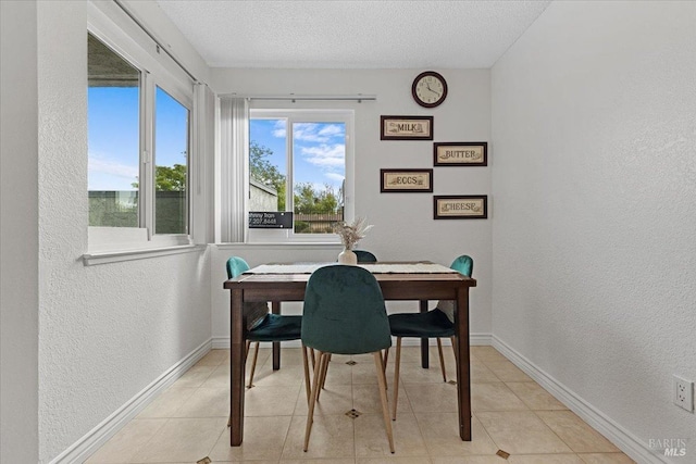 home office with baseboards, a textured ceiling, and a textured wall