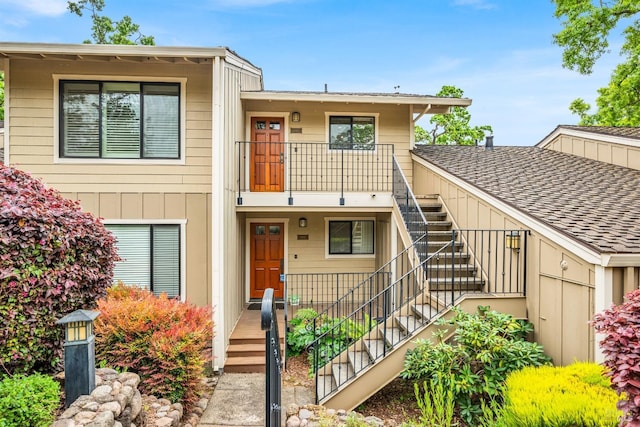multi unit property with a balcony and stairs