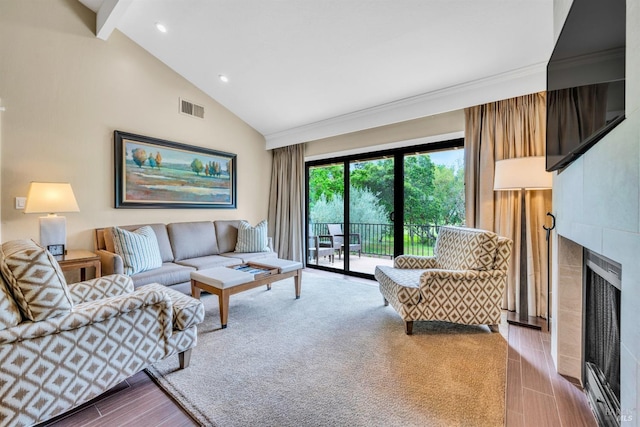 living room featuring high vaulted ceiling, a tile fireplace, beamed ceiling, visible vents, and recessed lighting