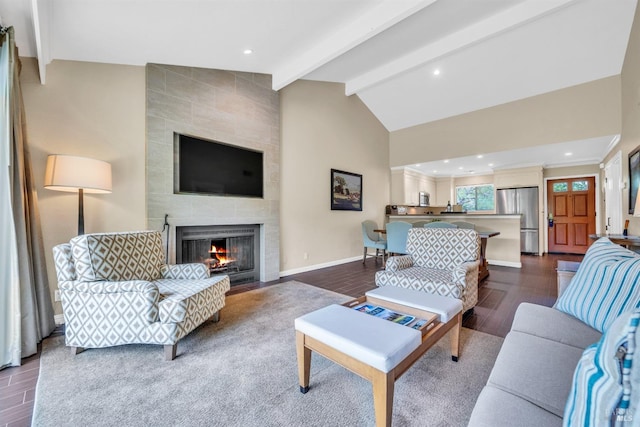 living room featuring recessed lighting, vaulted ceiling with beams, dark wood-type flooring, baseboards, and a tiled fireplace
