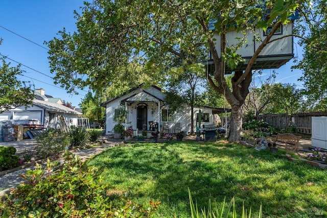 bungalow-style house with a front lawn and fence