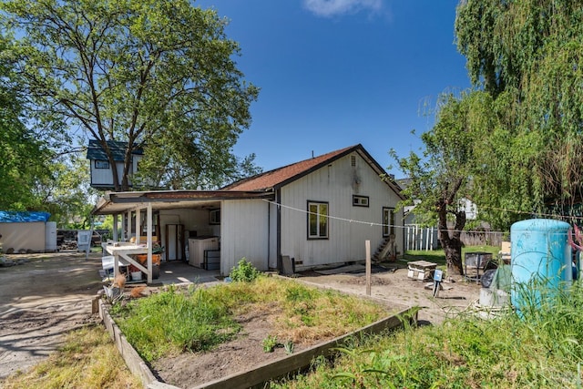 rear view of house featuring fence and a patio area
