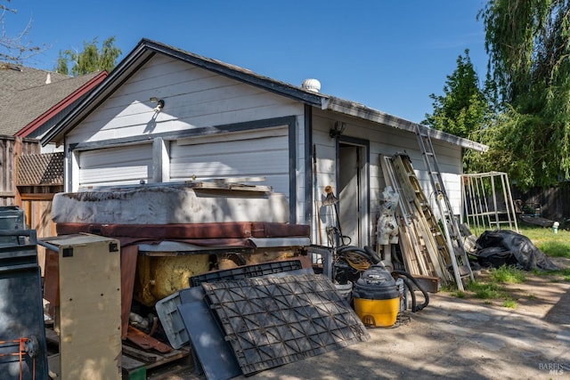 exterior space featuring an outdoor structure and fence