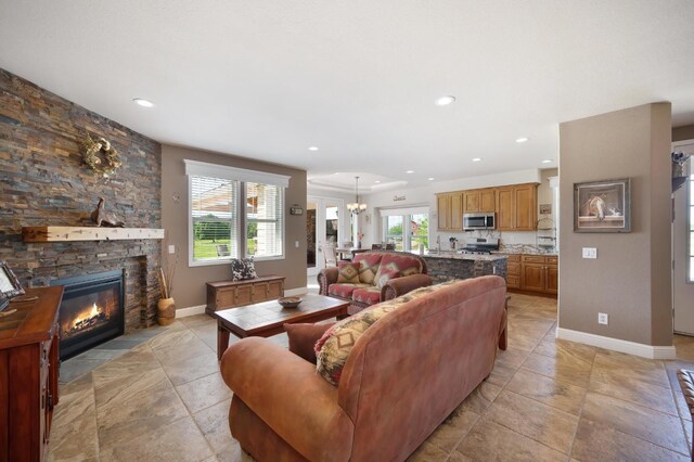living area featuring stone finish floor, recessed lighting, and a notable chandelier