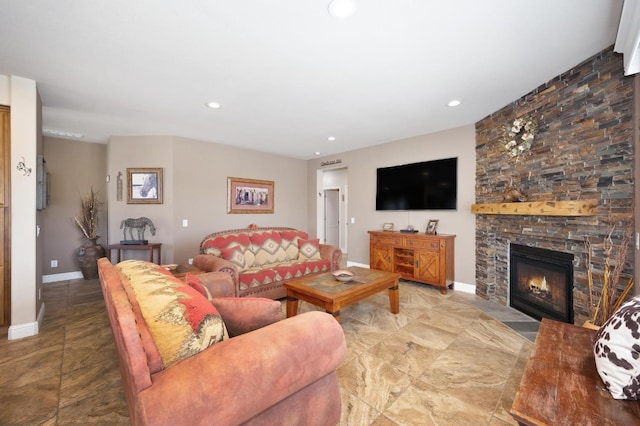 living room featuring baseboards, a fireplace, and recessed lighting