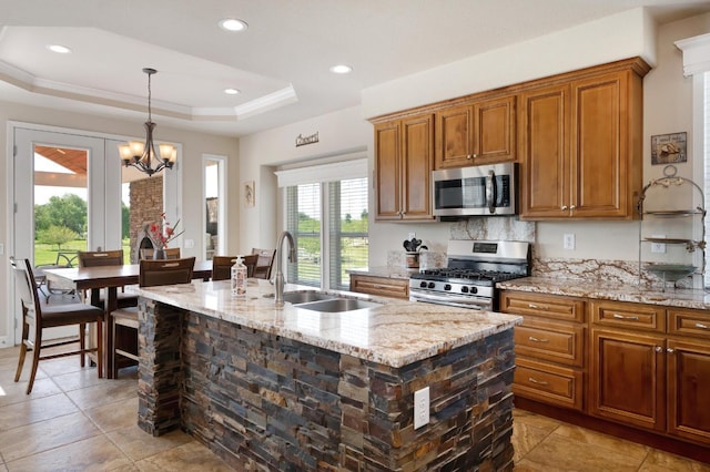 10240 Kost Rd, Galt, CA 95632 - kitchen featuring brown cabinets, stainless steel appliances, light stone countertops, and a sink