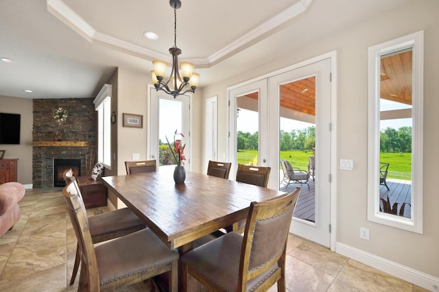 10240 Kost Rd, Galt, CA 95632 - dining area with a fireplace, light tile patterned floors, a raised ceiling, a chandelier, and recessed lighting