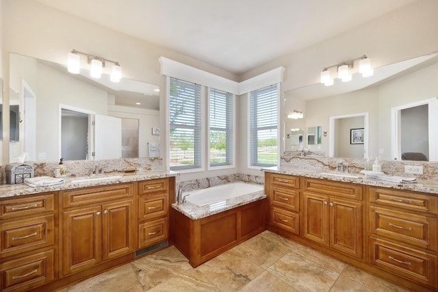 full bath featuring a garden tub, two vanities, a sink, and tiled shower