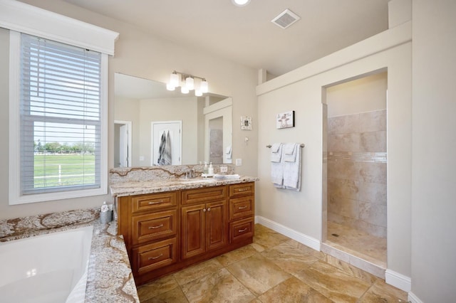 bathroom featuring a garden tub, vanity, visible vents, baseboards, and a walk in shower