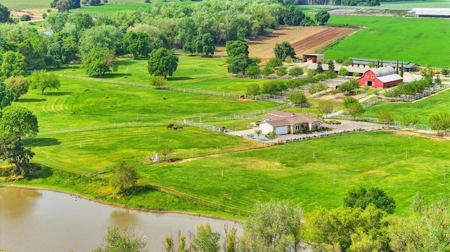 birds eye view of property featuring a water view and a rural view
