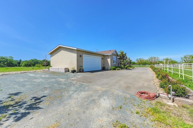 10240 Kost Rd, Galt, CA 95632 - view of property exterior featuring fence, driveway, and a garage