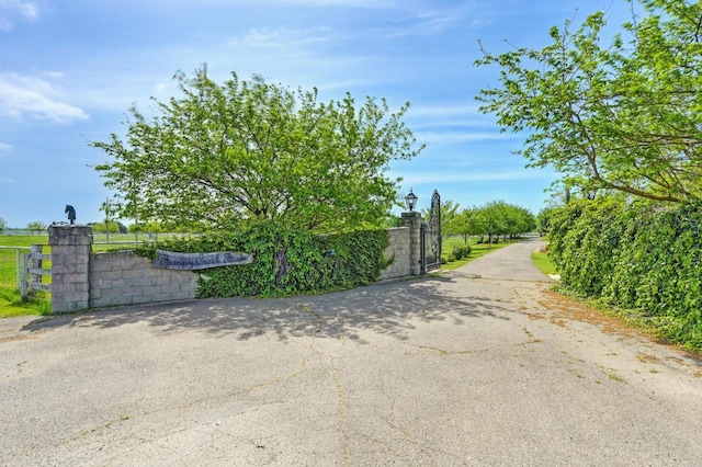 10240 Kost Rd, Galt, CA 95632 - view of street featuring a gate, a gated entry, and aphalt driveway
