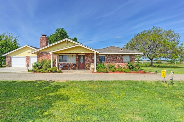 ranch-style house with a chimney, a front lawn, an attached garage, driveway, and brick siding