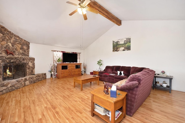 living area featuring ceiling fan, lofted ceiling with beams, light wood finished floors, and a fireplace