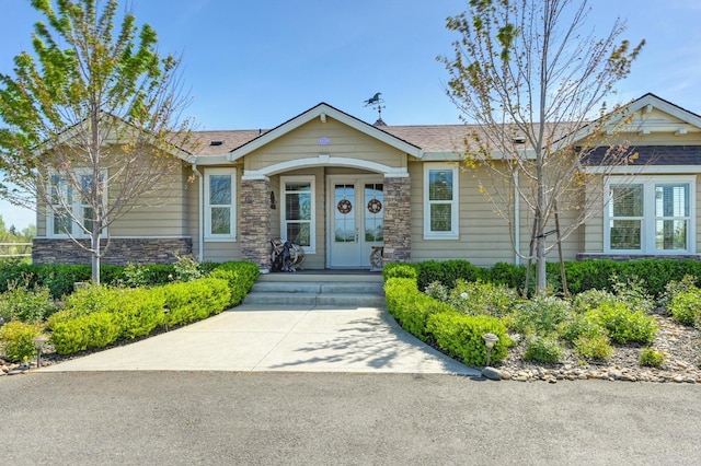 view of front of house with french doors and stone siding