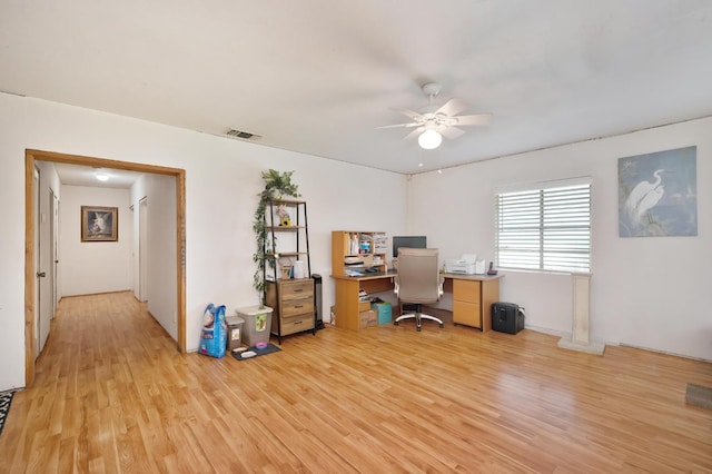 office space with light wood-style floors, visible vents, and a ceiling fan