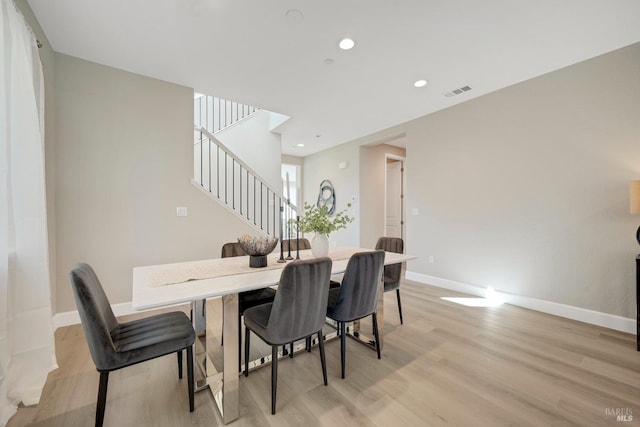 dining area featuring recessed lighting, light wood finished floors, visible vents, baseboards, and stairs