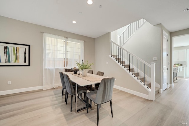 dining space with stairway, baseboards, recessed lighting, and light wood-type flooring