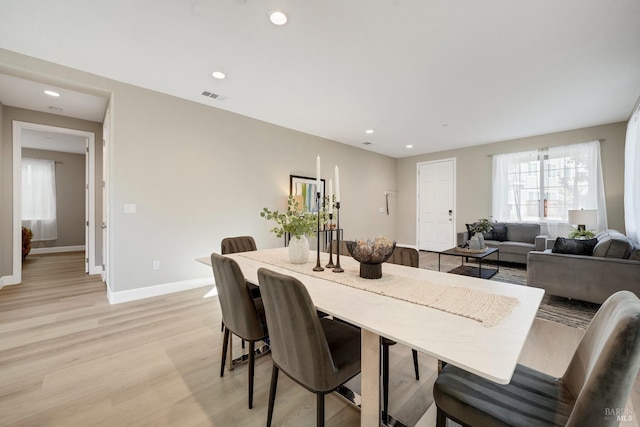 dining space featuring light wood-type flooring, baseboards, visible vents, and recessed lighting